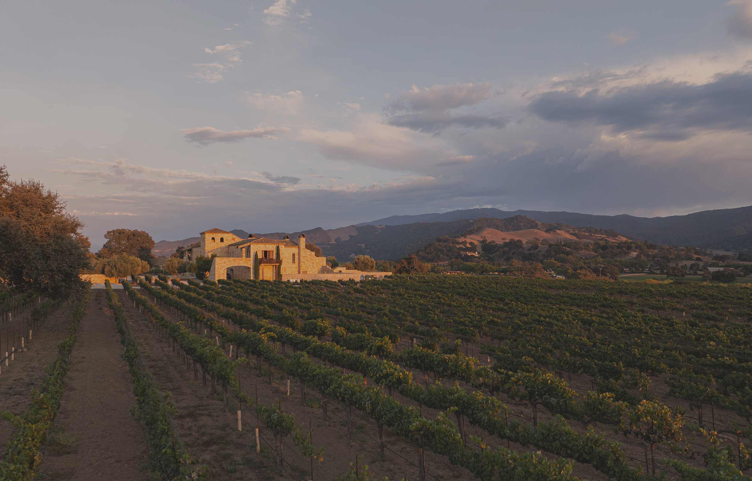 The Sunstone Villa above the estate vineyard at sunset