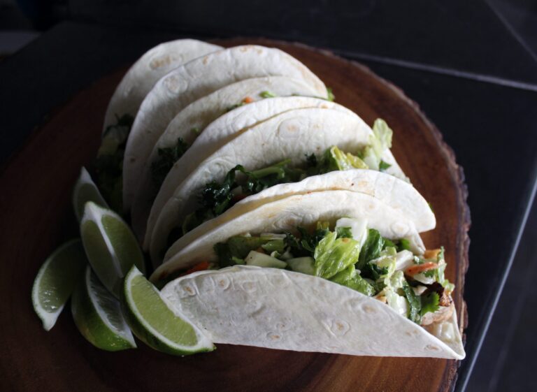 Grilled fish tacos topped with cabbage slaw and cilantro